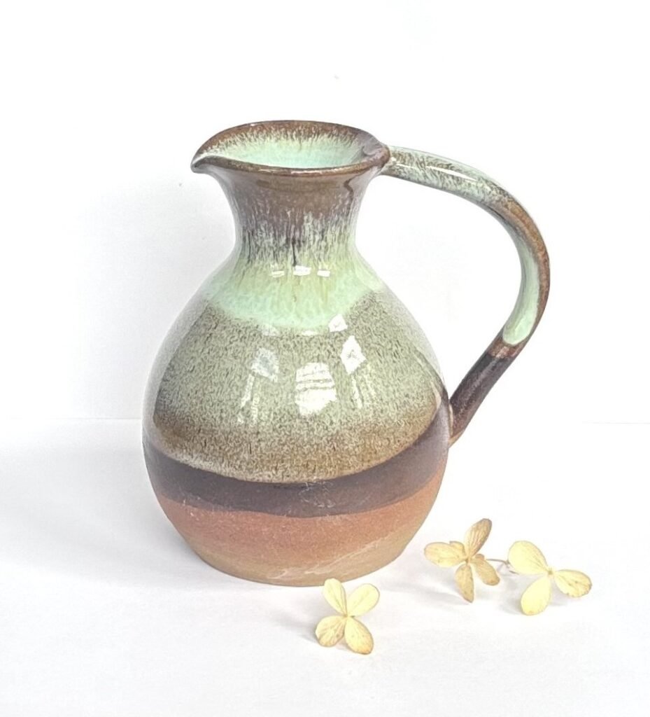 Handmade wheel-thrown stoneware jug with green and brown glaze